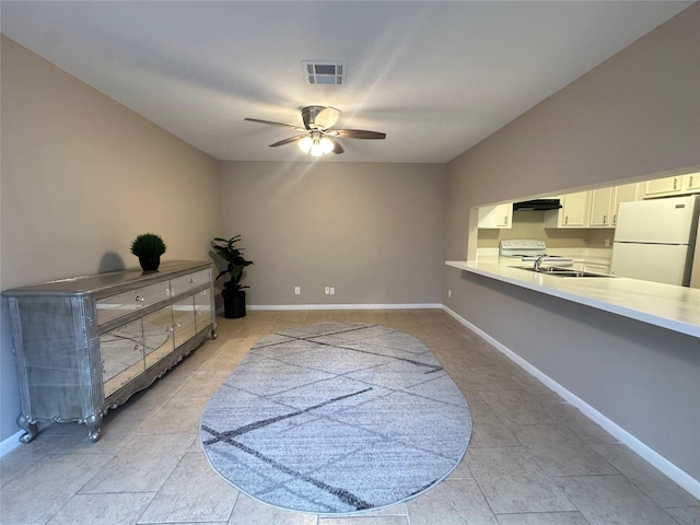 sitting room featuring visible vents, a ceiling fan, baseboards, and light tile patterned floors