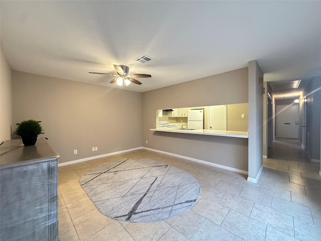 unfurnished living room with baseboards, ceiling fan, visible vents, and light tile patterned floors