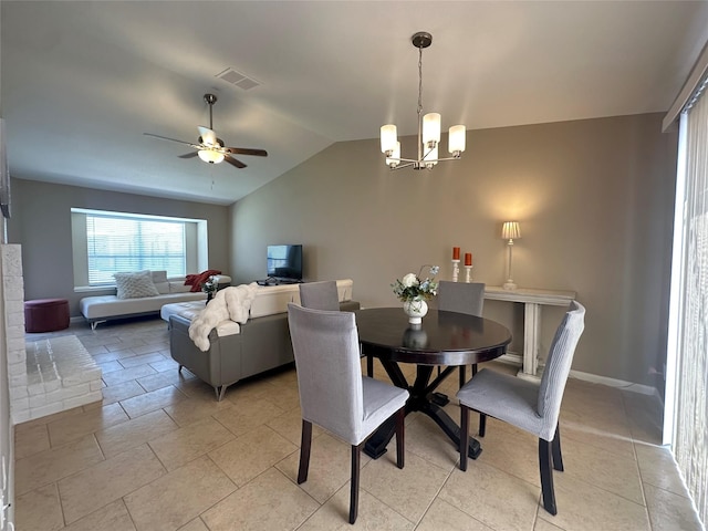 dining room with visible vents, ceiling fan with notable chandelier, and vaulted ceiling