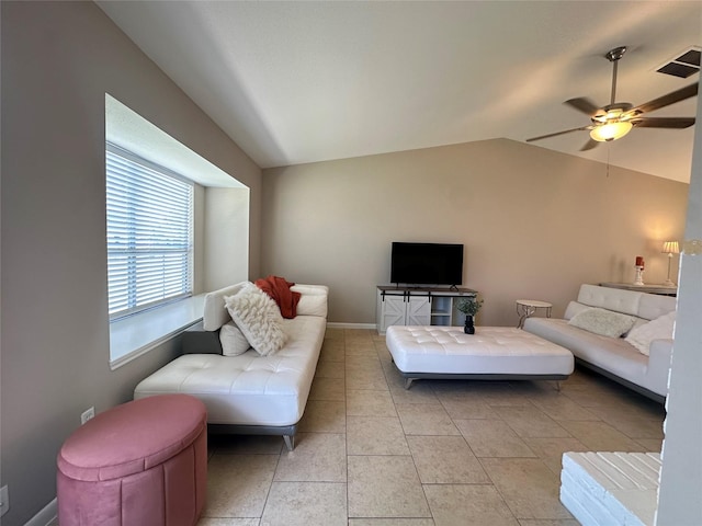 living area featuring baseboards, a ceiling fan, and lofted ceiling