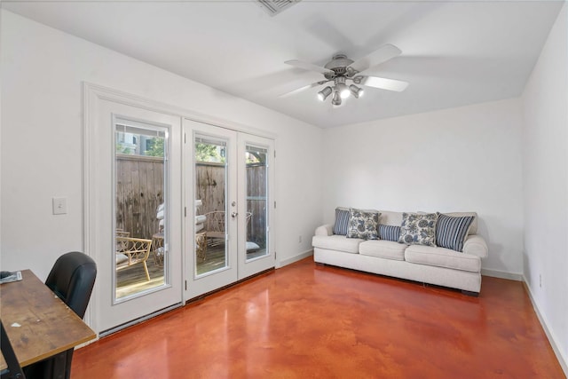 living room with concrete floors, an office area, baseboards, and ceiling fan