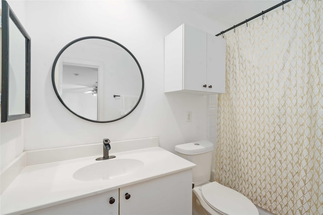 bathroom featuring toilet, ceiling fan, and vanity