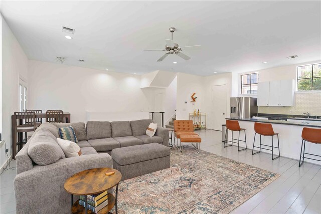 living area featuring ceiling fan, stairs, recessed lighting, and light wood-type flooring