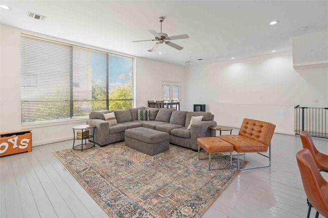 living room featuring plenty of natural light, a ceiling fan, hardwood / wood-style flooring, baseboards, and recessed lighting