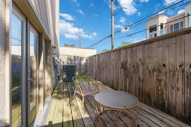 wooden terrace featuring cooling unit