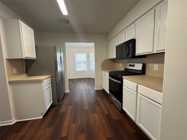 kitchen with light countertops, stainless steel appliances, dark wood-style flooring, and white cabinetry
