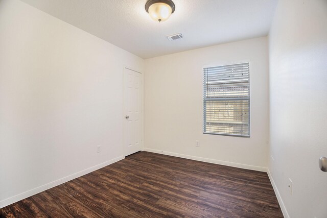 20906 Foxwood Glen Ln, Humble, TX 77338 - unfurnished room featuring dark wood-style flooring and baseboards