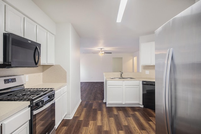 20906 Foxwood Glen Ln, Humble, TX 77338 - kitchen with black appliances, a sink, a peninsula, dark wood-style floors, and light countertops