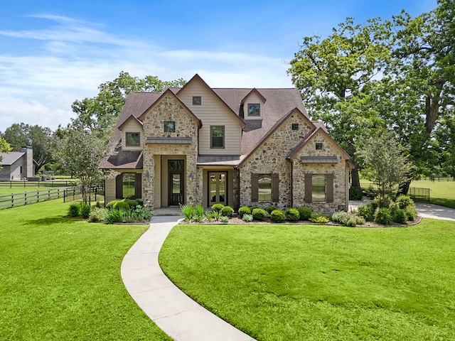 view of front of home with stone siding and a shingled roof