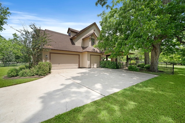 view of front of home with an attached garage, concrete driveway, and roof with shingles