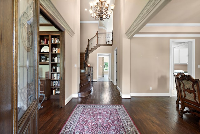 foyer with stairs, dark wood-style flooring, baseboards, a chandelier, and ornamental molding