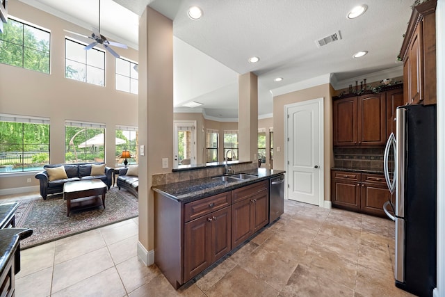 kitchen with appliances with stainless steel finishes, ceiling fan, a sink, recessed lighting, and open floor plan