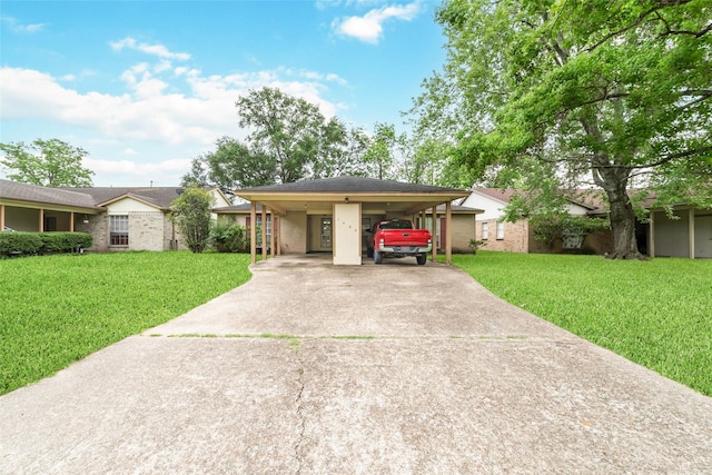ranch-style house featuring a carport, driveway, and a front yard