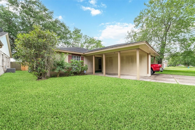 back of house featuring a lawn, fence, cooling unit, and driveway