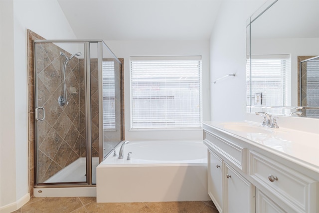 full bathroom featuring vanity, a bath, a stall shower, and tile patterned floors