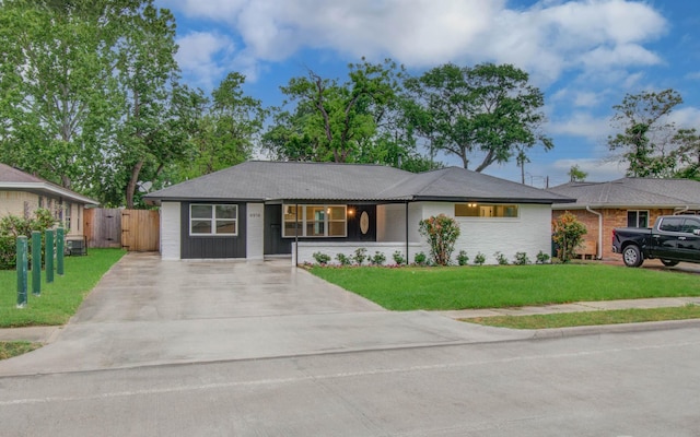single story home with a gate, fence, driveway, and a front yard
