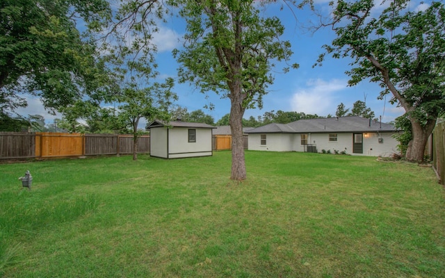 view of yard featuring an outbuilding and a fenced backyard