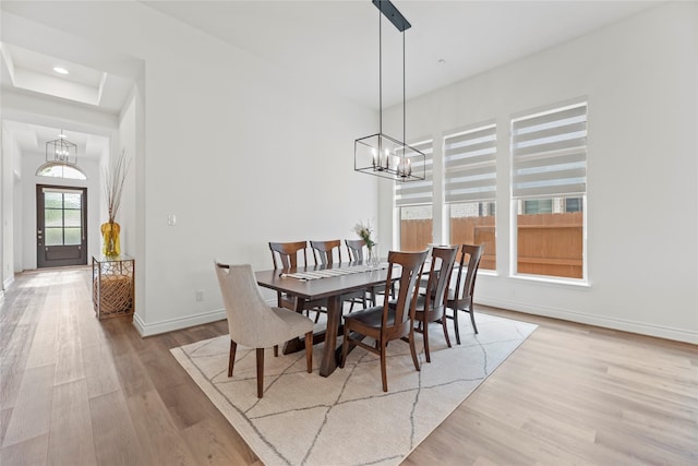 2122 Rosybill Dr, Katy, TX 77494 - dining area with wood finished floors, baseboards, an inviting chandelier, a tray ceiling, and recessed lighting