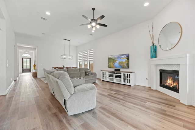 2122 Rosybill Dr, Katy, TX 77494 - living room with light wood finished floors, a glass covered fireplace, a ceiling fan, recessed lighting, and visible vents