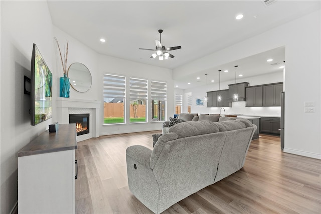 2122 Rosybill Dr, Katy, TX 77494 - living area featuring recessed lighting, light wood finished floors, a glass covered fireplace, and ceiling fan