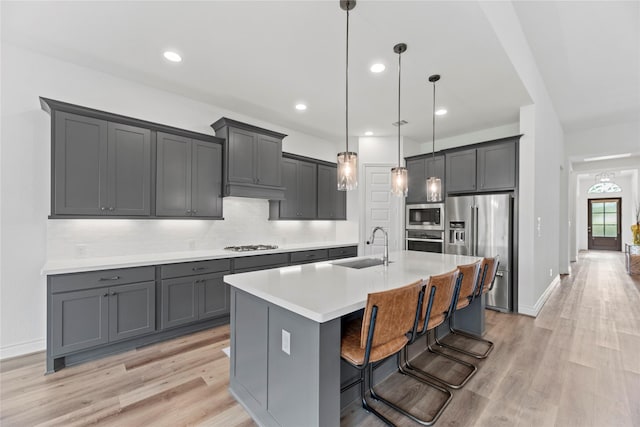 2122 Rosybill Dr, Katy, TX 77494 - kitchen with a sink, light wood finished floors, appliances with stainless steel finishes, and backsplash