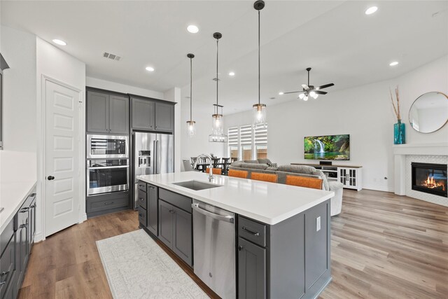 2122 Rosybill Dr, Katy, TX 77494 - kitchen featuring gray cabinets, visible vents, appliances with stainless steel finishes, open floor plan, and light wood-style flooring