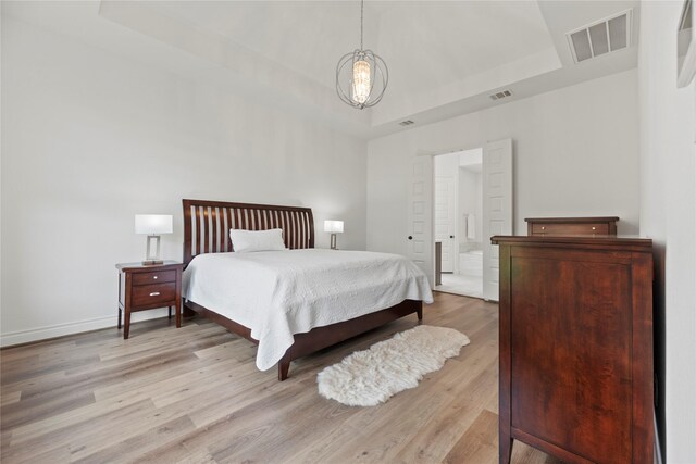 2122 Rosybill Dr, Katy, TX 77494 - bedroom featuring visible vents, a raised ceiling, baseboards, and light wood-type flooring