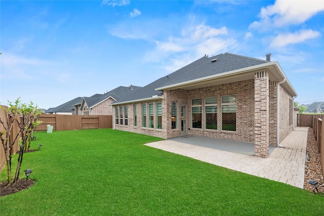 2122 Rosybill Dr, Katy, TX 77494 - back of house with a lawn, a patio area, brick siding, a fenced backyard, and a shingled roof
