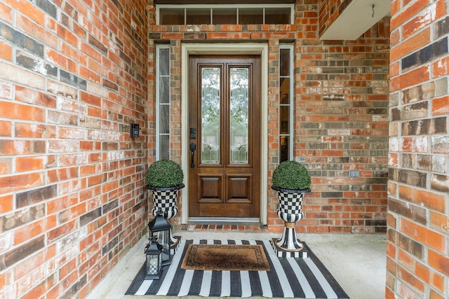 property entrance with brick siding and french doors