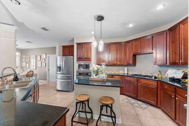 kitchen featuring visible vents, a sink, light tile patterned floors, and stainless steel appliances