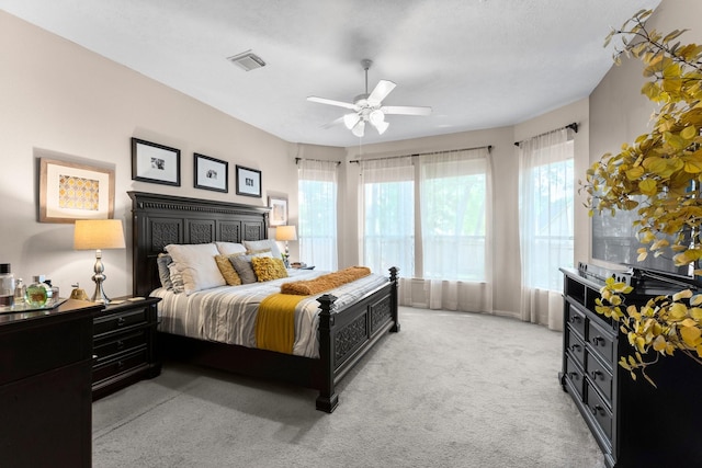 bedroom featuring ceiling fan, light carpet, and visible vents