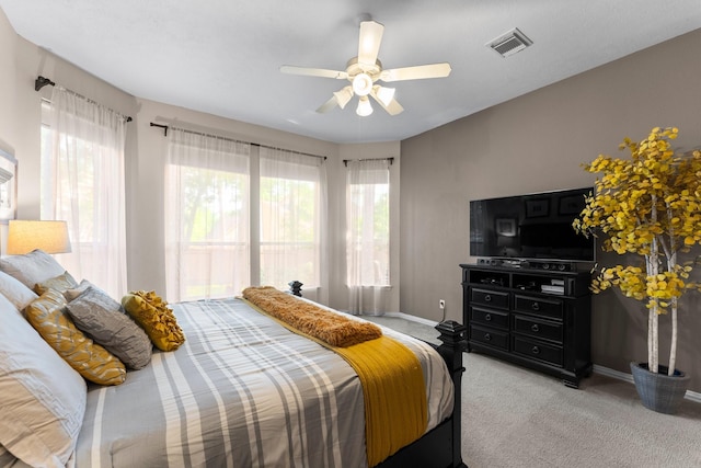 carpeted bedroom featuring visible vents, baseboards, and ceiling fan