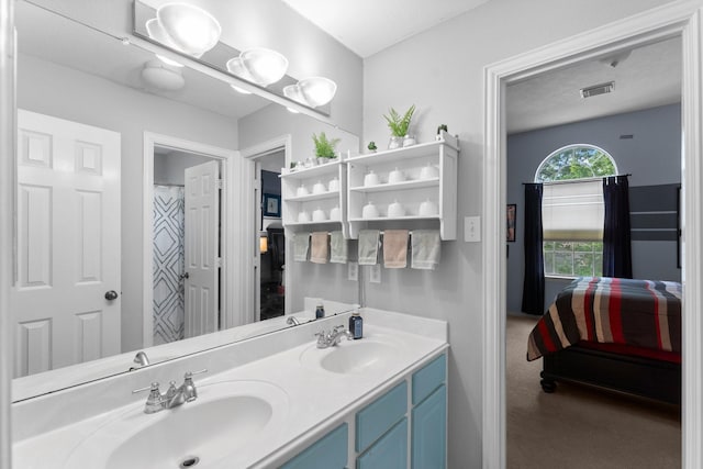 ensuite bathroom featuring visible vents, a sink, ensuite bath, and double vanity