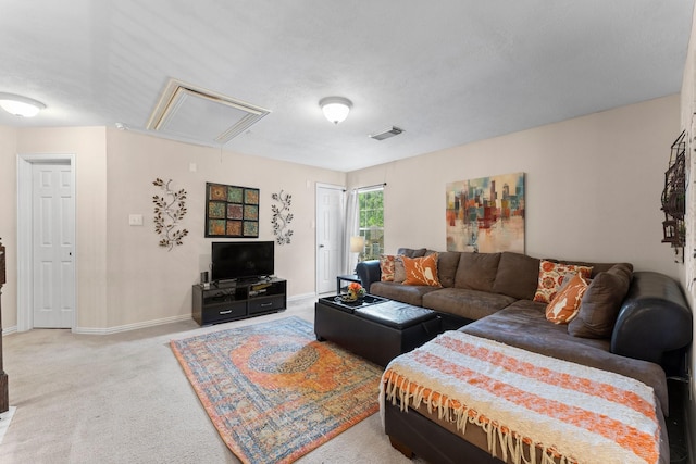 living area with baseboards, attic access, carpet flooring, and visible vents