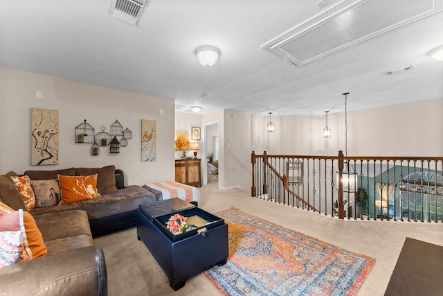 living area featuring visible vents and attic access