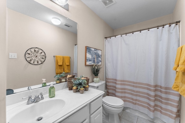 full bathroom featuring toilet, tile patterned floors, visible vents, and vanity