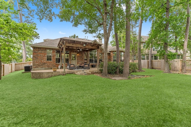 rear view of property featuring ceiling fan, cooling unit, a fenced backyard, a patio area, and a yard