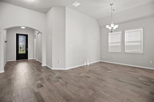 interior space featuring visible vents, arched walkways, a chandelier, and dark wood-style floors
