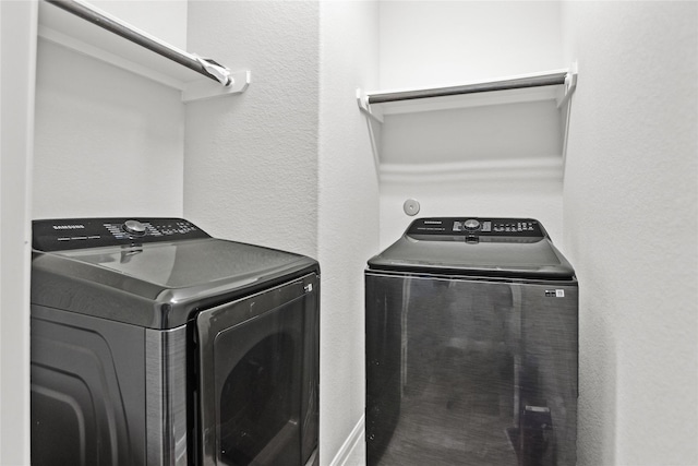 washroom featuring separate washer and dryer and laundry area
