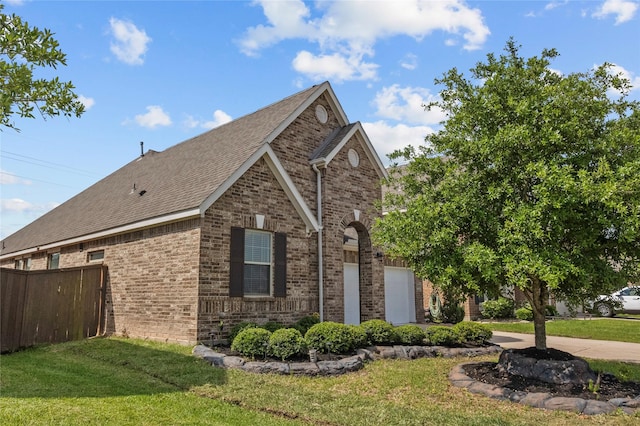 view of property exterior with fence, a shingled roof, a yard, and brick siding