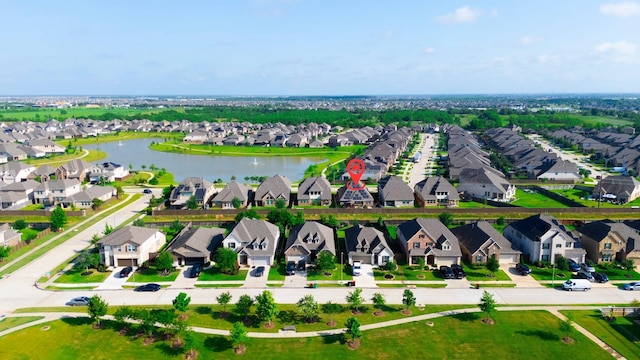 birds eye view of property with a residential view and a water view