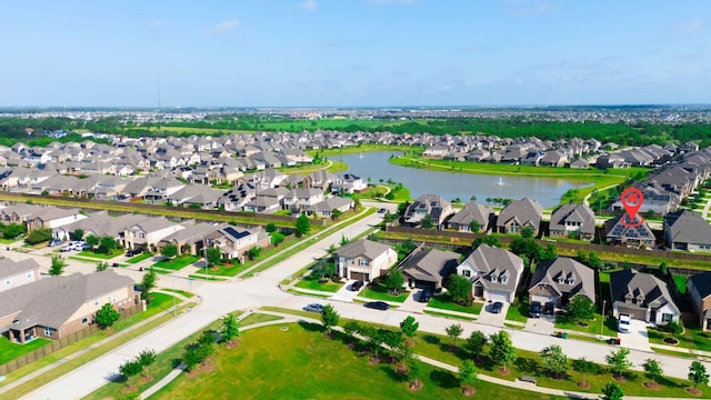 drone / aerial view featuring a residential view and a water view
