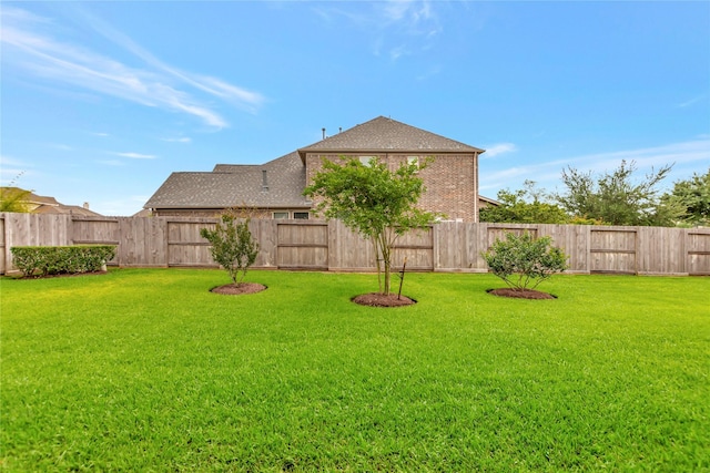 view of yard with a fenced backyard