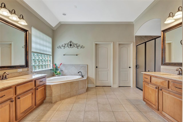 bathroom with crown molding, a sink, and a garden tub