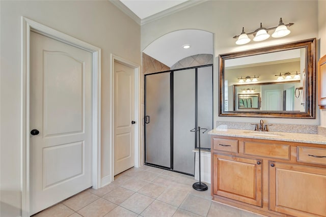 bathroom featuring crown molding, vanity, tile patterned flooring, and a stall shower