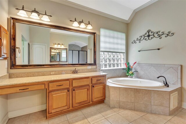 full bathroom featuring crown molding, tile patterned floors, a bath, and vanity