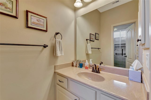 bathroom featuring vanity and visible vents