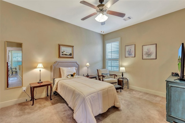bedroom featuring baseboards, multiple windows, light colored carpet, and visible vents