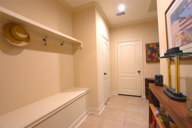mudroom featuring crown molding, light tile patterned floors, baseboards, and visible vents