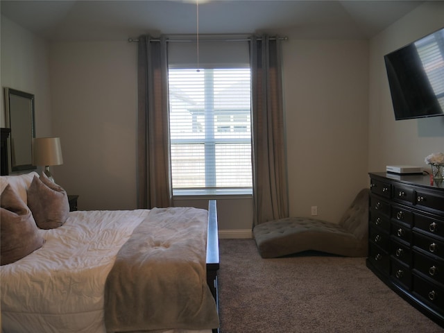 carpeted bedroom with baseboards and vaulted ceiling